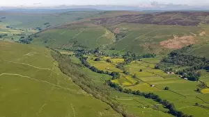 Aerial view of a quaint Yorkshire Dales village nestled among vibrant buttercup meadows
