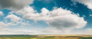 Wonderland Prints: Aerial View Of Rain Clouds Above Coniferous Forest Pines Woods Landscape In Early Spring Day