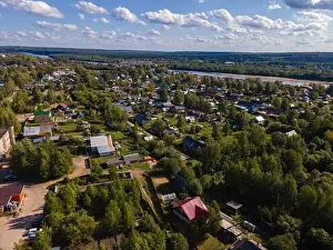 aerial view residential houses near summer river and huge metal bridge