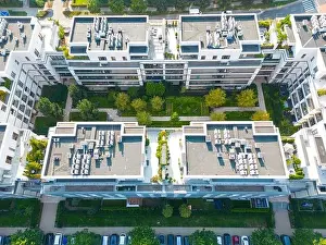 Parking Lots Prints: Aerial view of residential houses neighborhood and apartment building complex at sunset