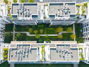 Parking Lots Prints: Aerial view of residential houses neighborhood and apartment building complex at sunset