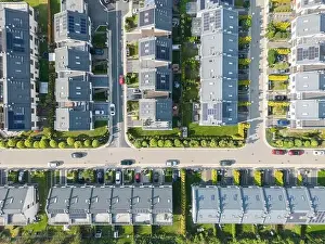 Parking Lots Prints: Aerial view of residential houses neighborhood and apartment building complex at sunset