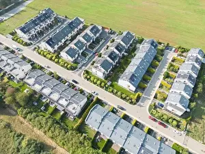 Aerial view of residential houses neighborhood and apartment building complex at sunset