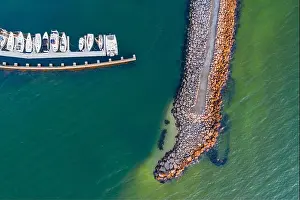 Top Down Prints: Aerial view of a rocky breakwater protecting a line of boats moored at a marina at Sandringham in Melbourne
