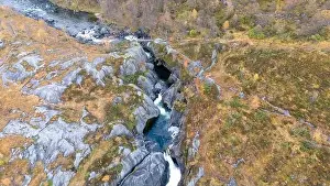 Directly Above Prints: Aerial view of a rocky landscape with a river flowing through a narrow gorge surrounded by autumn foliage