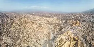 Uneven Prints: Aerial view of rough rugged mounts with uneven surface forming natural valley