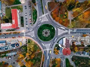 Travel Technology Prints: Aerial view of roundabout road with circular cars in small european city at autumn cloudy day