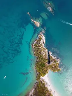 Watercraft Prints: Aerial view of the rugged coastline where turquoise waters embrace the rocky shores