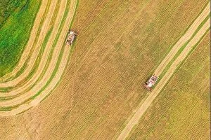 Aerial Landscape Collection: Aerial View Of Rural Landscape. Two Combines Harvesters Working In Field, Collects Seeds