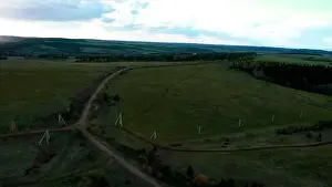 Sustainable Lifestyle Prints: Aerial view of a rural road in the middle of green endless meadows