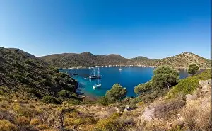 Aerial view of sailing boat anchored in turquoise color wonderful sea bay