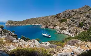 Aerial view of sailing boat anchored in turquoise color wonderful sea bay