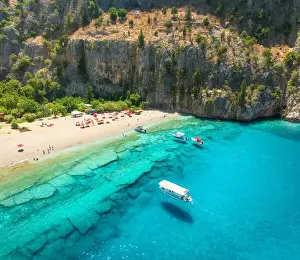 Fethiye Prints: Aerial view of sandy beach, blue sea, boats, rock, umbrellas
