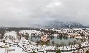 Moat Prints: Aerial view of Schloss Anif castle moated in artificial pond Salzburg outskirts in snow in winter view of untersberg