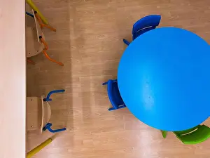 Back To School Prints: Aerial view of a school classroom, with brown and colored chairs and tables
