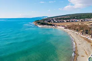 Surfer Prints: Aerial view of sea coast with sandy beach and small buildings
