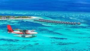 Images Dated 19th April 2016: Aerial view of a seaplane approaching island in the Maldives. Maldives beach from birds eye view