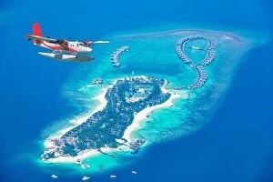 Images Dated 4th January 2017: Aerial view of a seaplane approaching island in the Maldives. Maldives beach from birds eye view