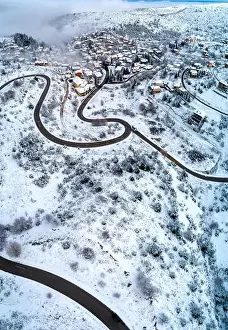 Winter City Prints: Aerial View of Seli Traditional Greek Village Covered by Snow in Winter Morning