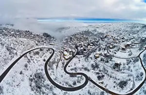 Winter City Prints: Aerial View of Seli Traditional Greek Village Covered by Snow in Winter Morning