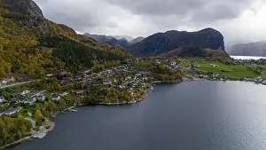 Aerial view of a serene fjord landscape with a small village nestled along the shore
