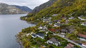 Aerial view of a serene fjord landscape with a small village nestled along the shore