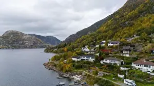 Aerial view of a serene fjord landscape with a small village nestled along the shore