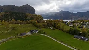 Aerial view of a serene fjord landscape with a small village nestled along the shore