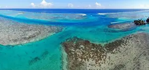 Aerial view of shades of blue and coral reefs over the Moorea lagoon in French Polynesia, South Pacific