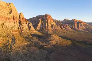 An aerial view shows a rugged mountain landscape that rises from the desert surrounding Las Vegas, Nevada. This dry area averages over 95 degrees F