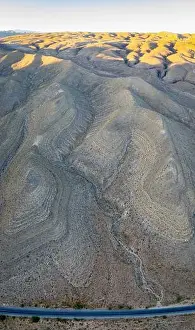 An aerial view shows a rugged mountain landscape that rises from the desert surrounding Las Vegas, Nevada. This dry area averages over 95 degrees F
