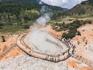 Aerial view of Sikidang crater with the background of sulfur vapor coming out of the sulfur marsh