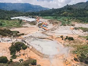 Central Java Prints: Aerial view of Sikidang crater with the background of sulfur vapor coming out of the sulfur marsh