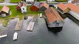 Aerial view of a small coastal village featuring a harbor