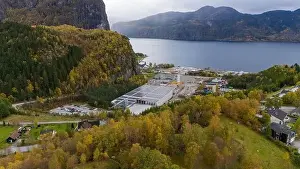 Directly Above Prints: Aerial view of a small factory with solar panels on roof near a fjord in Norway