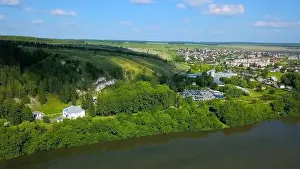 Suburbia Prints: Aerial view of a small green village surrounded by green forest