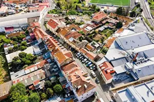 Slum Prints: Aerial view of a small residential district in Lisbon outskirt along a railway