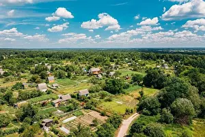Aerial View Of Small Town, Village Cityscape Skyline In Summer Day. Residential District, Houses And Vegetable Garden Beds In Bird's-eye View
