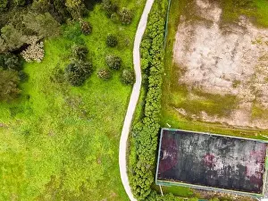 Maintained Prints: Aerial view of a small walkway trail going offroad in the wood in Monsanto national park on the hill