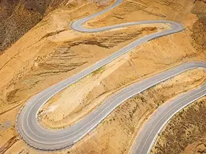 Serpentine Prints: Top aerial view of snake curved road