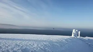 Aerial view over snow covered stone blocks and white valley. Clip. Manpupuner in winter on a blue sky background