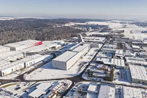 Baden Wuerttemberg Prints: Aerial view of a snowy industrial area with factory buildings and adjacent forest