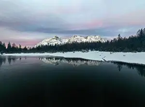 Waters Edge Prints: Aerial view of snowy peaks mirrored in the frozen lake Entova at dawn