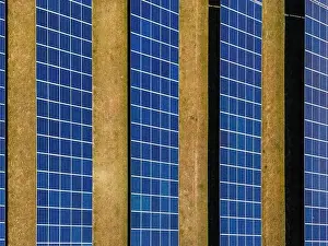 Solar Panels Prints: Aerial view of solar modules of a ground-mounted photovoltaic system on a field as a top view from above