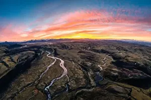 Aerial view of Spectacular moss on lava field with river flowing in Icelandic highlands on wilderness in the sunset