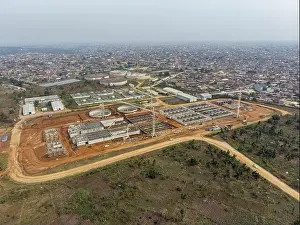 Dense Prints: Aerial view of a sprawling industrial complex with cylindrical tanks and rectangular buildings