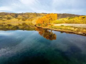 Aerial view of stunning autumn colors around a tranquil New Zealand lake in Queenstown
