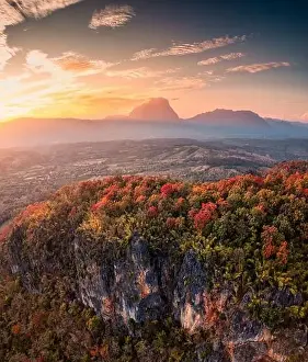 Chiang Mai Prints: Aerial view of sunset over Doi Luang Chiang Dao mountain range with colorful autumn forest on hill in countryside