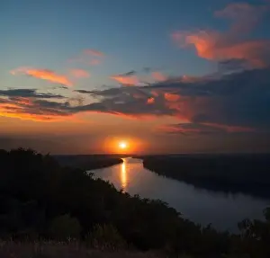 Sun Cloud Prints: Aerial view of sunset river. Drone flying over the river at dawn with beautiful sky