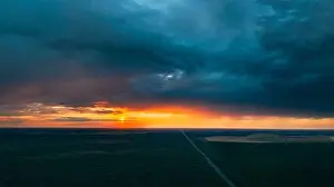 Sunray Prints: Aerial View Of Sunset Sky Above Highway Road Through Green Forest Landscape In Sunny Evening